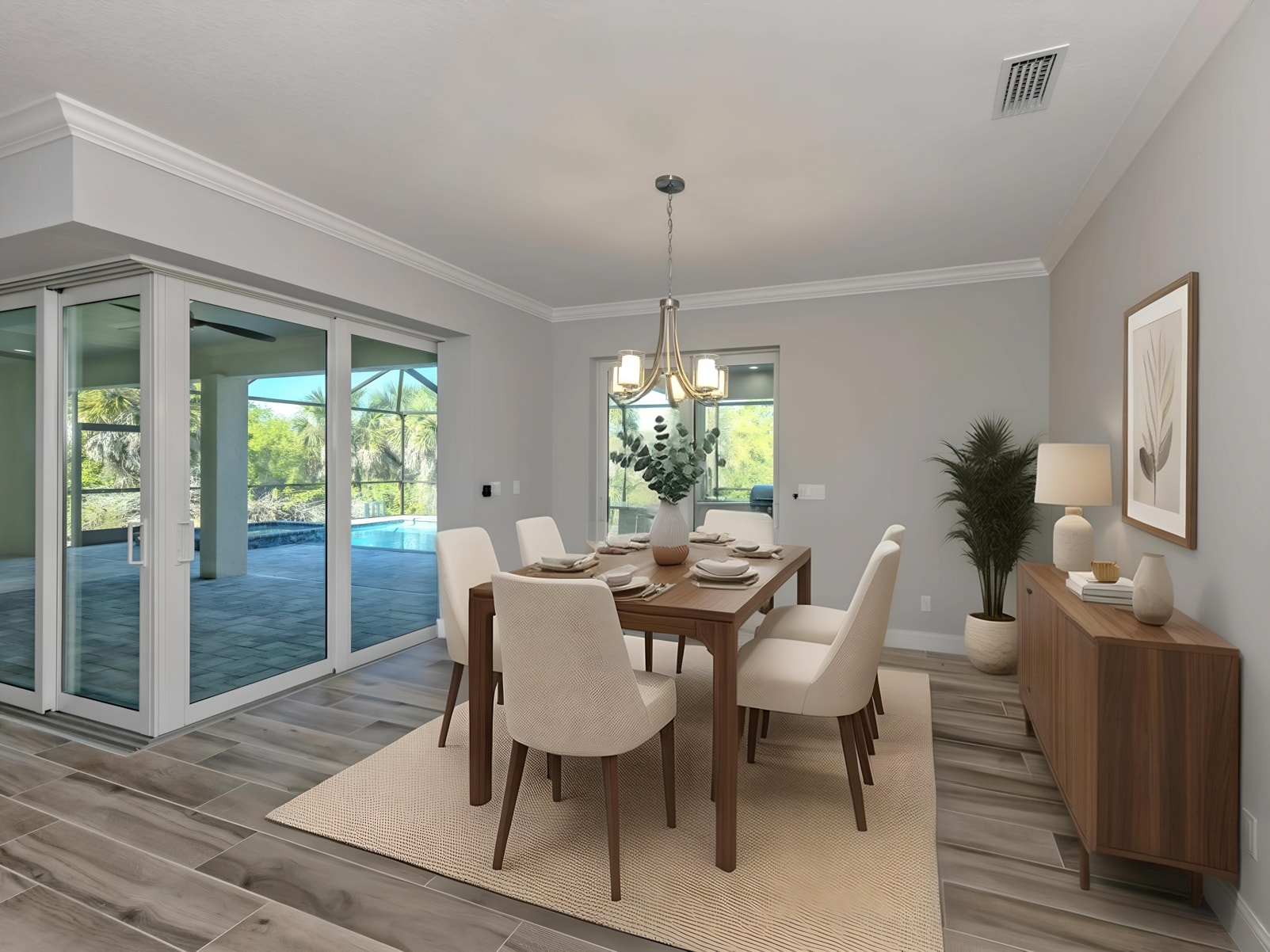 Dining room with pool lanai access and chandelier